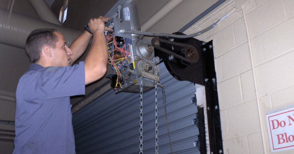 Technician fixes garage door.