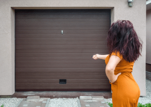 person using remote on garage door
