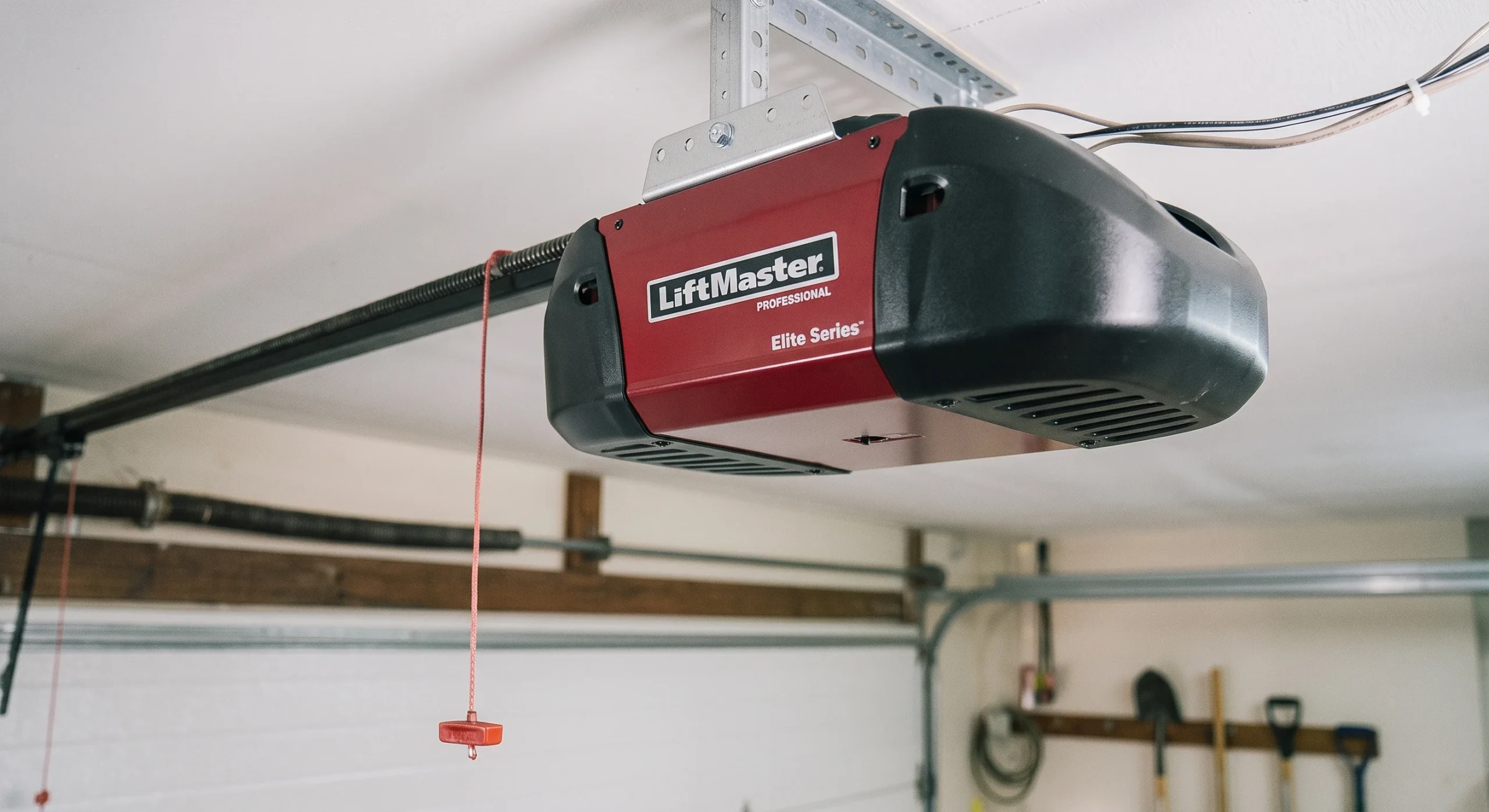 A close-up view of a ceiling-mounted red LiftMaster Elite Series opener unit to Fix Smart Garage Door Opener Problems.